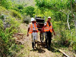 goldquest local drillers carrying a man-portable drill